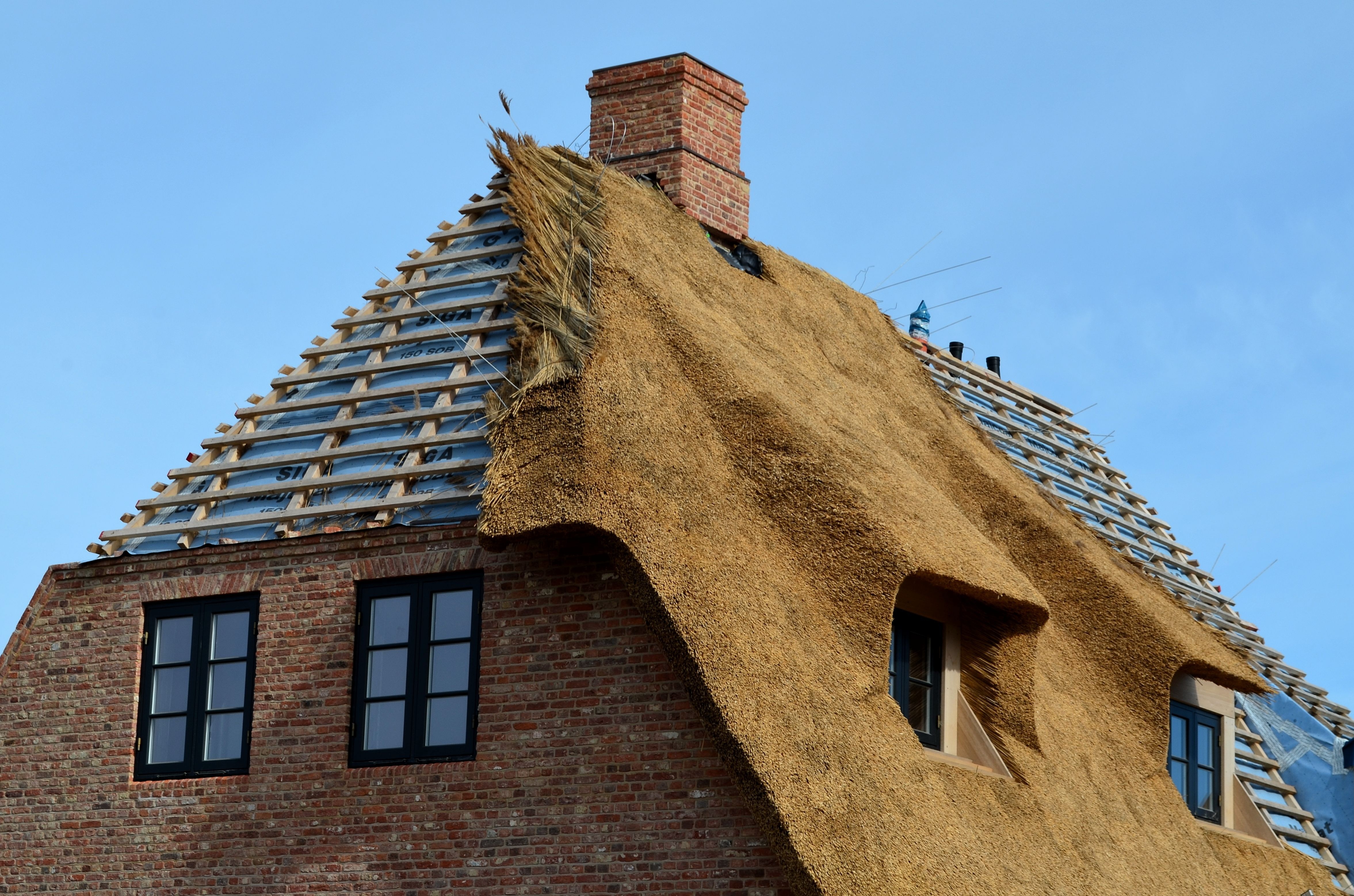 Ralph Thatch team constructing a thatched roof